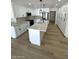 Bright kitchen boasts white cabinets, stainless steel appliances, and a large center island at 3933 E Flower St, Phoenix, AZ 85018