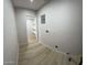 Laundry room space featuring modern flooring and walk-in closet at 3933 E Flower St, Phoenix, AZ 85018