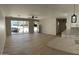 Open floor plan living room with a ceiling fan, many windows, and light wood floors at 3933 E Flower St, Phoenix, AZ 85018