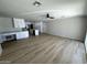 Spacious living room area featuring light wood floors, recessed lights, and a ceiling fan at 3933 E Flower St, Phoenix, AZ 85018