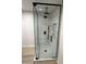Modern glass shower with black hardware, rain shower head, and built in shelves at 3933 E Flower St, Phoenix, AZ 85018