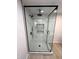Open glass shower with black trim, rain shower head, and built-in shower caddies at 3933 E Flower St, Phoenix, AZ 85018