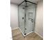 Modern glass shower with black hardware, tiled walls, and built in shelves at 3933 E Flower St, Phoenix, AZ 85018