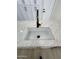 A close-up of the kitchen sink shows quality fixtures and pristine countertop at 3933 E Flower St, Phoenix, AZ 85018