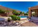 Serene backyard with lush landscaping, privacy wall, and cozy pool area at 408 E Silverwood Dr, Phoenix, AZ 85048
