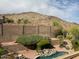 Inviting backyard pool with desert landscaping and mountain views for a serene outdoor living experience at 408 E Silverwood Dr, Phoenix, AZ 85048