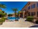 Relaxing backyard oasis featuring a sparkling pool, mature trees, and ample patio space at 408 E Silverwood Dr, Phoenix, AZ 85048