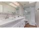 Modern bathroom featuring double sinks, white cabinetry, and walk-in shower at 408 E Silverwood Dr, Phoenix, AZ 85048