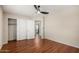 This bedroom has wood floors, a ceiling fan, and a closet with sliding doors at 408 E Silverwood Dr, Phoenix, AZ 85048