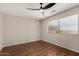 This bedroom has wood floors, a ceiling fan, and a window with blinds at 408 E Silverwood Dr, Phoenix, AZ 85048