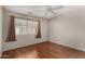 This bedroom has hardwood floors, a ceiling fan, and a window at 408 E Silverwood Dr, Phoenix, AZ 85048