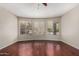 Bedroom featuring wood floors, ceiling fan and large windows at 408 E Silverwood Dr, Phoenix, AZ 85048
