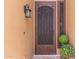 Charming front door with decorative security screen, lantern, and potted plants at 408 E Silverwood Dr, Phoenix, AZ 85048