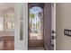Front door with decorative screen allowing views to palm trees and desert landscape at 408 E Silverwood Dr, Phoenix, AZ 85048