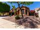 Inviting two-story house with desert landscaping, mature trees, and a spacious three-car garage at 408 E Silverwood Dr, Phoenix, AZ 85048