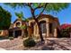 Inviting two-story home with desert landscaping, mature trees, and a spacious three-car garage at 408 E Silverwood Dr, Phoenix, AZ 85048
