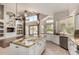 Open-concept kitchen featuring white cabinets, granite counters, stainless appliances, and pendant lights at 408 E Silverwood Dr, Phoenix, AZ 85048