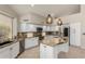 Well-lit kitchen features white cabinets, granite countertops, and stainless steel appliances at 408 E Silverwood Dr, Phoenix, AZ 85048