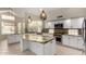 Bright kitchen boasts white cabinets, granite countertops, stainless steel appliances, and pendant lighting at 408 E Silverwood Dr, Phoenix, AZ 85048