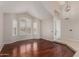 Bright living room with wood floors, modern lighting, and front door access at 408 E Silverwood Dr, Phoenix, AZ 85048