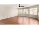 This living room features wood floors, a ceiling fan, and a window with blinds at 408 E Silverwood Dr, Phoenix, AZ 85048