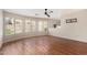 This living room features wood floors, a ceiling fan, and a window with blinds at 408 E Silverwood Dr, Phoenix, AZ 85048