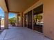 Covered patio with sliding glass doors and views of the lush backyard at 408 E Silverwood Dr, Phoenix, AZ 85048