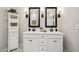 Spacious bathroom with a double vanity, sleek mirrors, and ample storage at 42440 W Peters Dr, Maricopa, AZ 85138