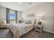 Cozy bedroom featuring a comfortable bed, a window with natural light, and stylish decor at 42440 W Peters Dr, Maricopa, AZ 85138
