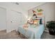 Themed bedroom with colorful decor, window, and side table at 42440 W Peters Dr, Maricopa, AZ 85138