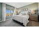Charming bedroom featuring a queen bed, side tables, and natural light from a window at 42440 W Peters Dr, Maricopa, AZ 85138