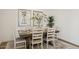 Stylish dining room with a wood table, seating for six, and attractive wall decor at 42440 W Peters Dr, Maricopa, AZ 85138