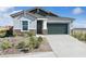 Charming single-story home features desert landscaping, a two-car garage and covered entryway at 42440 W Peters Dr, Maricopa, AZ 85138