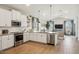 Beautiful kitchen featuring white cabinets, stainless steel appliances and island with pendant lighting at 42440 W Peters Dr, Maricopa, AZ 85138