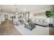 Cozy living room featuring an open layout, modern decor, and wood-look tile flooring at 42440 W Peters Dr, Maricopa, AZ 85138