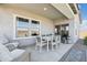 Covered patio with an outdoor dining set and cushioned seating, perfect for entertaining at 42440 W Peters Dr, Maricopa, AZ 85138
