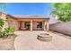 Lovely backyard with a fire pit, covered patio, and a vibrant sunflower bush at 4323 S Ranger Trl, Gilbert, AZ 85297