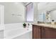 Bathroom showcasing a garden tub, granite countertop, and modern fixtures for a spa-like experience at 4323 S Ranger Trl, Gilbert, AZ 85297