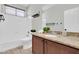 Functional bathroom featuring a shower-tub combo, granite countertop, and storage for everyday essentials at 4323 S Ranger Trl, Gilbert, AZ 85297