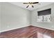An empty bedroom features a window and dark brown wood floors, creating a modern aesthetic at 4323 S Ranger Trl, Gilbert, AZ 85297