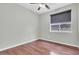 An empty bedroom features a window and dark brown wood floors, creating a modern aesthetic at 4323 S Ranger Trl, Gilbert, AZ 85297