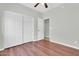 This bright bedroom features a wall closet, and dark brown wood floors, creating a modern aesthetic at 4323 S Ranger Trl, Gilbert, AZ 85297