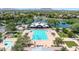 Aerial view of a community pool with ample seating, sun umbrellas, and a separate pool at 4323 S Ranger Trl, Gilbert, AZ 85297