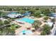 Inviting community pool with a large swimming area, a clubhouse, lounge chairs, and mature trees at 4323 S Ranger Trl, Gilbert, AZ 85297