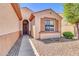 Charming single-story home showcasing a neutral exterior, decorative shutters, and well-maintained landscaping at 4323 S Ranger Trl, Gilbert, AZ 85297
