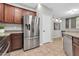 A modern kitchen featuring stainless steel appliances, granite counters, and warm wood cabinetry at 4323 S Ranger Trl, Gilbert, AZ 85297
