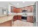 Modern kitchen featuring granite countertops, stainless steel appliances, and ample storage at 4323 S Ranger Trl, Gilbert, AZ 85297