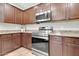 Well-equipped kitchen with dark wood cabinets and stainless steel appliances at 4323 S Ranger Trl, Gilbert, AZ 85297