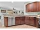 Open kitchen with granite countertops, stainless steel dishwasher and dark wood cabinetry at 4323 S Ranger Trl, Gilbert, AZ 85297