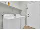 A bright laundry room features white appliances and cabinetry, offering a clean and functional space at 4323 S Ranger Trl, Gilbert, AZ 85297